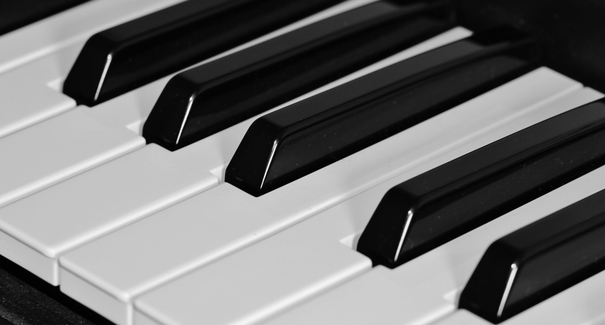 High-resolution close-up of piano keys showcasing the elegant black and white contrast.